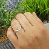 0.06 Carat (ctw) Sterling Silver Round Green Emerald & White Diamond Ladies Crossover Swirl Bridal Promise Engagement Ring
