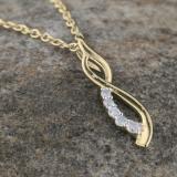 0.08 Carat (ctw) Round White Diamond Ladies Flame Shape Pendant 14K Yellow Gold