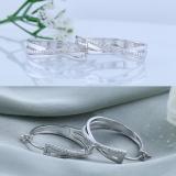 Ladies Round White Accents Diamond Infinity Crossover Huggies Hoops Earrings | 925 Sterling Silver